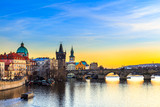 Fototapeta Pomosty - View of the Vltava River and Charles bridge shined with the sunset sun, Prague, the Czech Republic