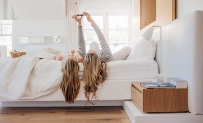 Wall Mural - Young family taking selfie in bed