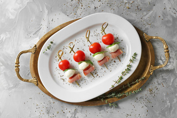 Sticker - Set of delicious canapes on plate, top view