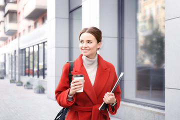 Young beautiful businesswoman beside office building