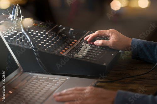 Fotografia, Obraz DJ working at radio broadcasting studio,hands adjusting volume and keyboard