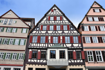 Wall Mural - Front view of three old typical half-timbered houses with shutters. Tubingen, Baden-Wurttemberg, Germany.