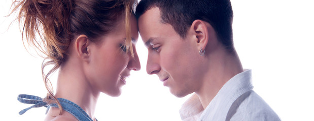 Young couple in love hugging and touching isolated on white background