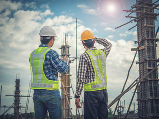 Two young man architect on a building construction site