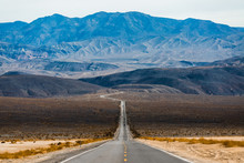 Road In The Death Valley National Park With Mountains On The Horizon. USA