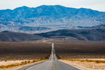 Road in the Death Valley National Park with mountains on the horizon. USA