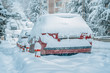 snowbound cars on street under heavy snow