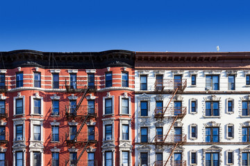 Wall Mural - Block of old buildings in New York City with blue sky background