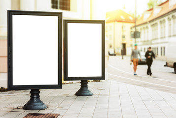 Two blank advertising billboards on the city street