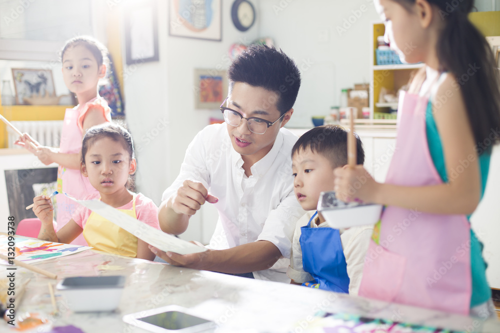 Little children in art class with teacher Stock Photo | Adobe Stock