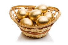 Golden Eggs In A Basket Isolated On White Background