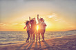 © FS-Stock - group of happy young people dancing at the beach on beautiful summer sunset