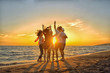 © FS-Stock - group of happy young people dancing at the beach on beautiful summer sunset