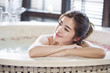 © Blue Jean Images - Beautiful young woman in bathtub with rose petals
