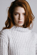 © irinaneva - portrait of cute young pretty attractive girl with long Red hair white warm sweater on natural snowy. advertising space