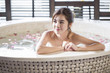© Blue Jean Images - Beautiful young woman in bathtub with rose petals