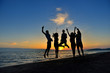 © FS-Stock - group of happy young people dancing at the beach on beautiful summer sunset