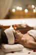 © Blue Jean Images - Beautiful young woman relaxing on massage table in a spa
