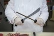 © Wavebreak Media - Butcher sharpening his knife
