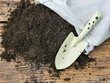 Organic soil with bag for planting on wood background