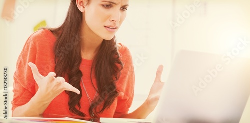Fotografie, Obraz Annoyed designer gesturing in front of her laptop