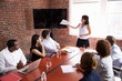 © Monkey Business - Businesswoman Addressing Boardroom Meeting With Screen