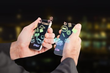 Poster - Composite image of businessman holding a phone in each hand 3d