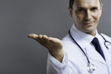 Handsome doctor making gesture with his hand