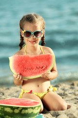 Canvas Print - Cute girl eating watermelon on beach