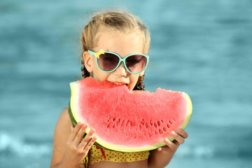 Canvas Print - Cute girl eating watermelon on beach