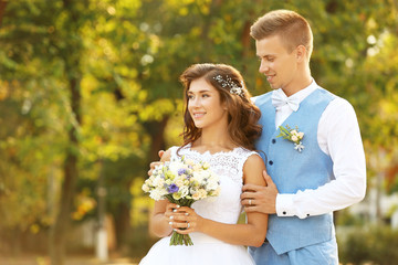 Wall Mural - Portrait of beautiful wedding couple on blurred background