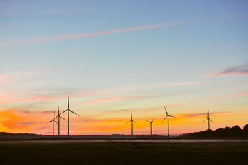 Wall Mural - Silhouette of wind turbine on sunset