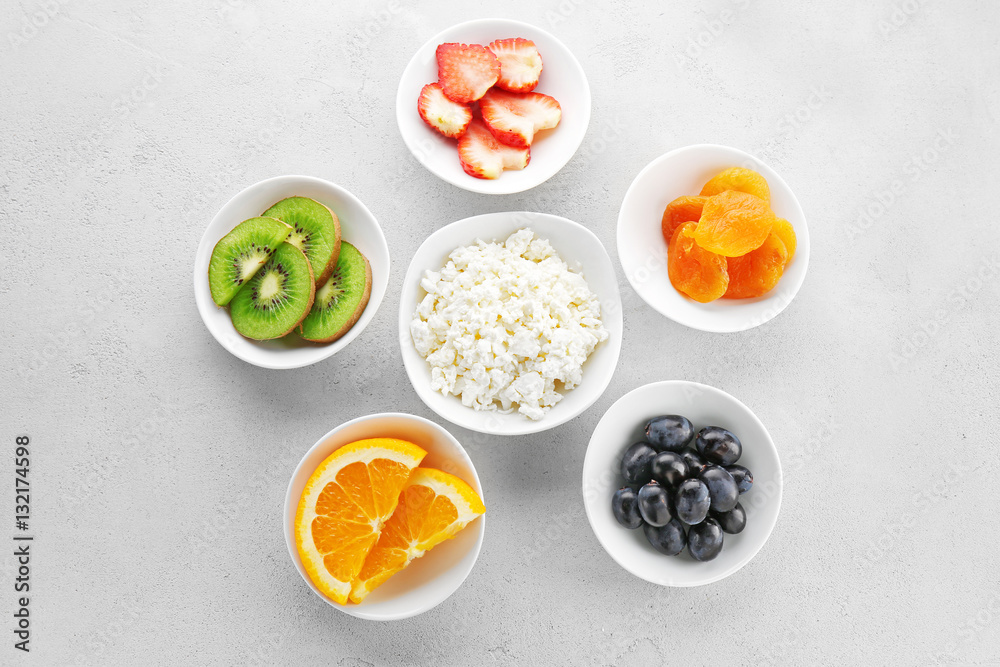 Set of diet products in saucers on grey textured background