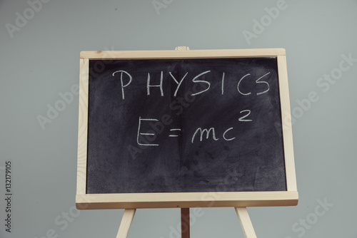 Physics word and formula E=mc2 on chalkboard Poster