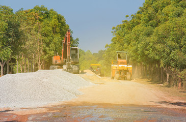 Excavator loader machine during earthmoving works street at construction site with sunlight