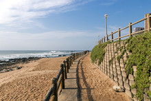 Retaining Wall And Wooden Barrier On Empty Beach