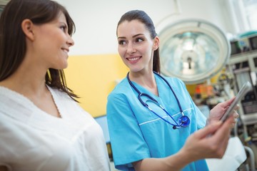 Poster - Female nurse assisting patient on digital tablet