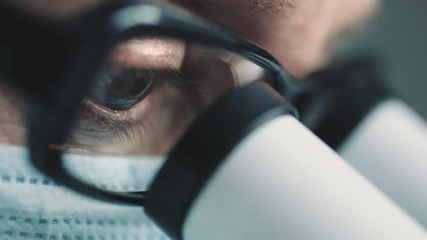 Wall Mural - middle age female scientist in uniform and medical face mask doing microscopic examination in labora