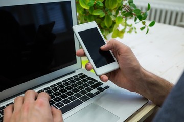 Aufkleber - Graphic designer using mobile phone at his desk