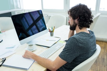 Aufkleber - Graphic designer writing in a diary at his desk