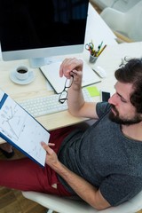 Aufkleber - Business executive looking at clipboard at his desk