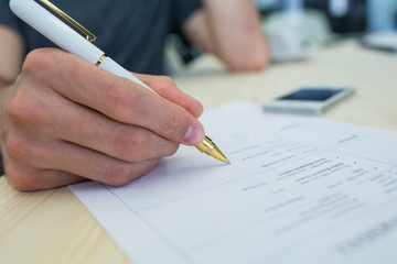 Aufkleber - Business executive writing on a document