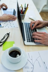 Poster - Business executive using laptop at his desk