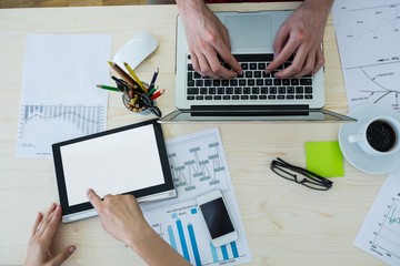 Aufkleber - Business executive using laptop and digital tablet at his desk
