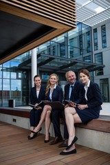 Poster - Businesspeople sitting with laptop in office premises