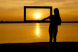 © ittipol - silhouette girl with frame on sunset background