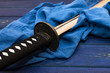 japan katana sword on the wood background with the blue shawl
