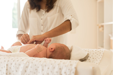 Wall Mural - mother changing baby's diaper