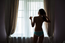 Girl With Cup Near Window. Woman In Panties. Early Sunday Morning.