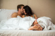 © DenisProduction.com - Feet of couple under blanket. Caucasian man and woman indoor. Romance and home comfort.